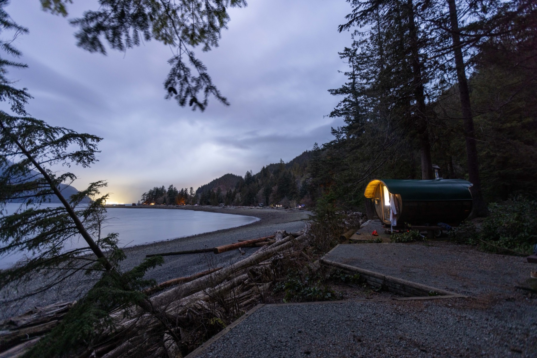 The barrel sauna glowing at dusk